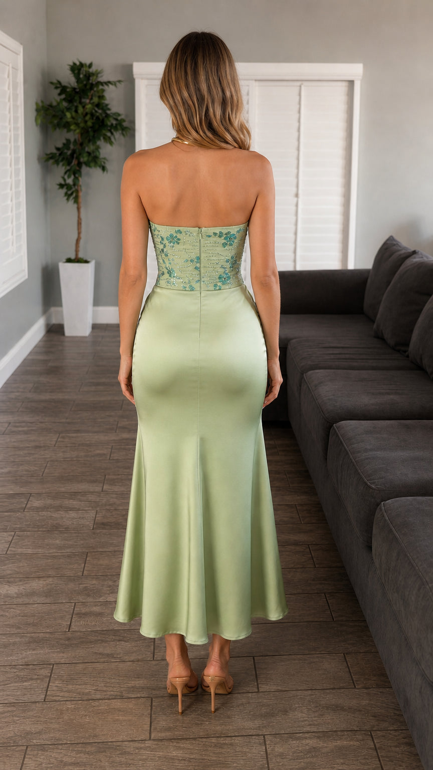 Back view of model showcasing silhouette of sage green midi dress