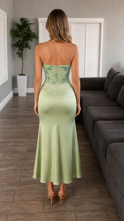 Back view of model showcasing silhouette of sage green midi dress