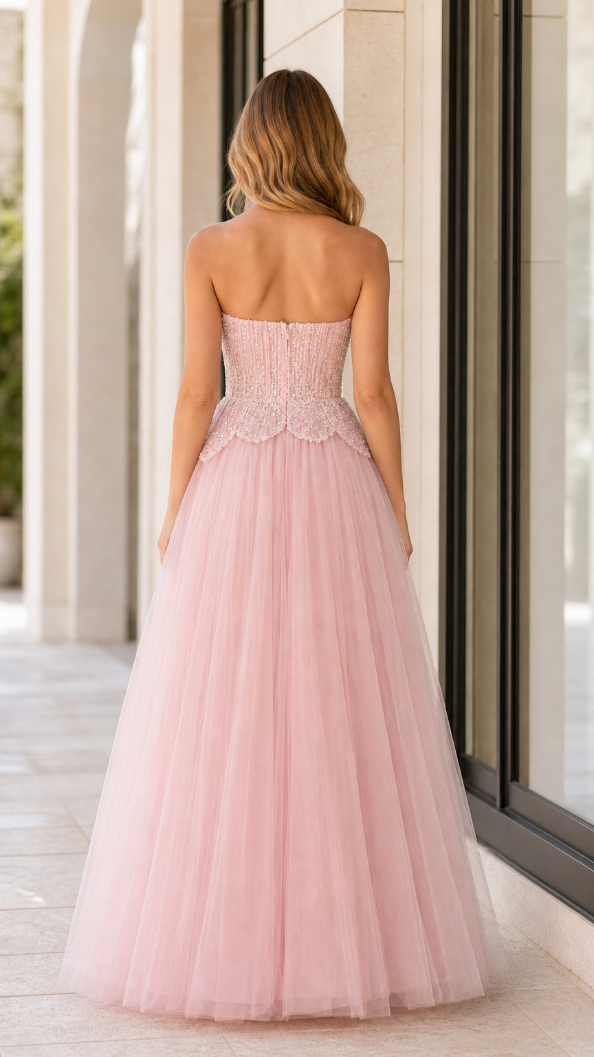 Back view of blush pink strapless tulle evening gown