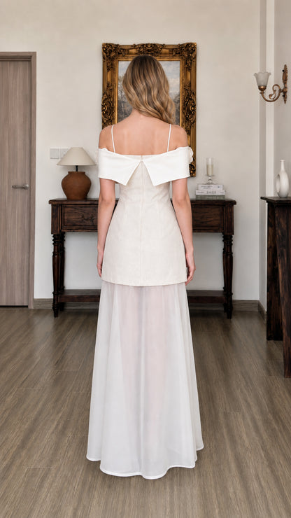 Back view of model showing folded collar detail on white dress
