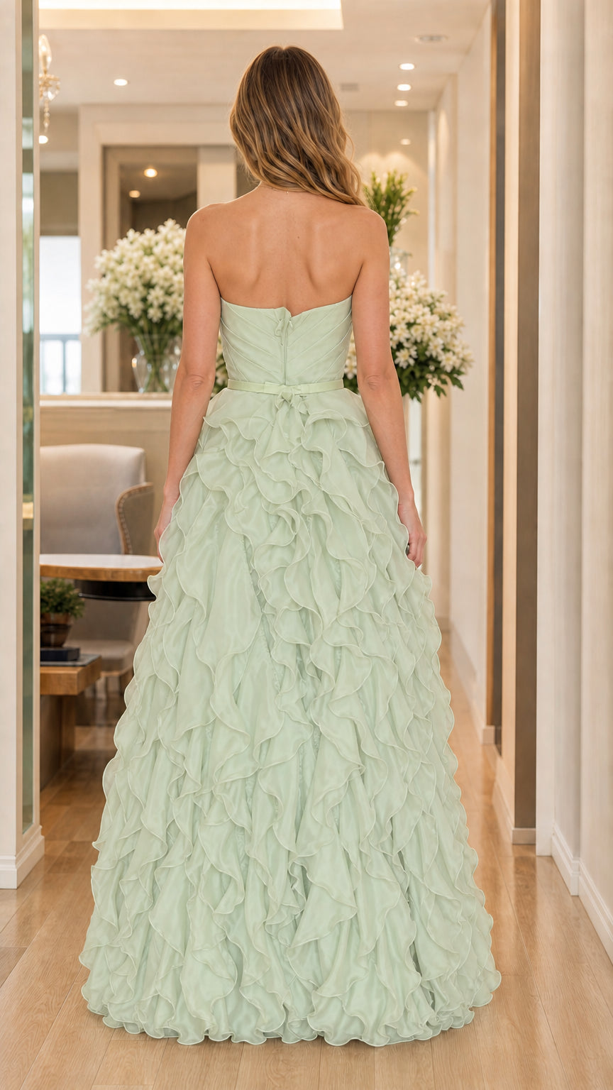 Back view of model in sage green strapless gown