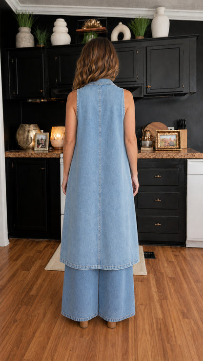 Back view of woman wearing light blue longline denim vest