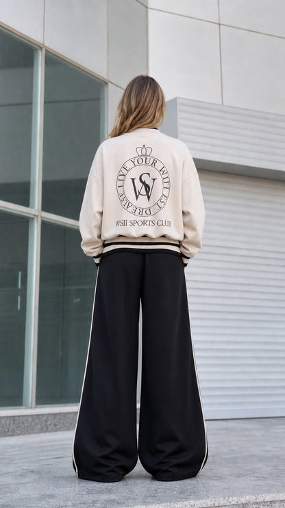 Back view of beige bomber jacket showing vintage sports club crest print
