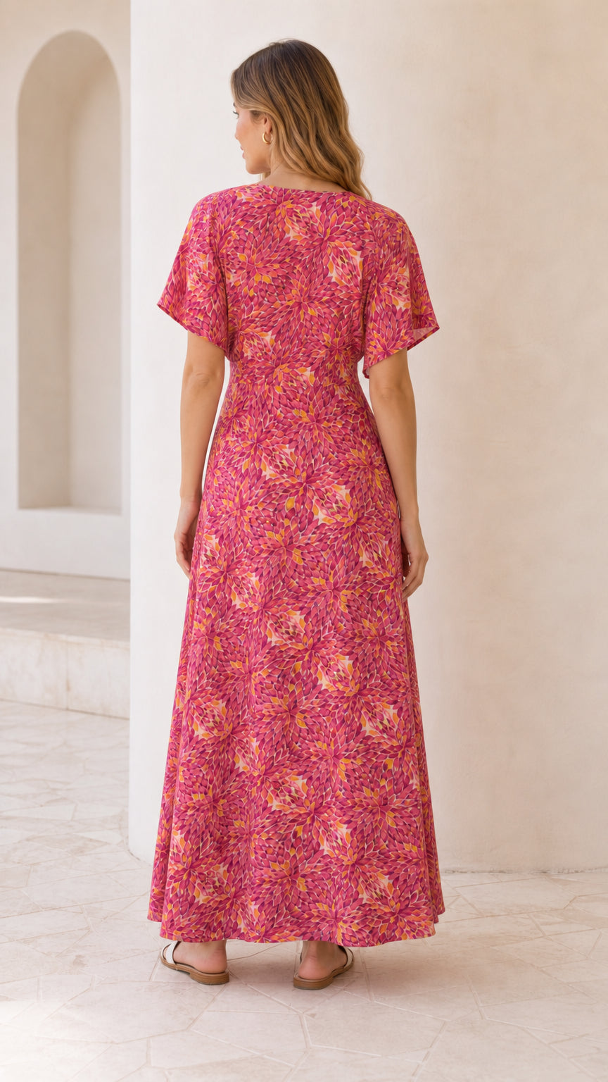 Back view of model wearing fuchsia pink floral flutter sleeve maxi dress