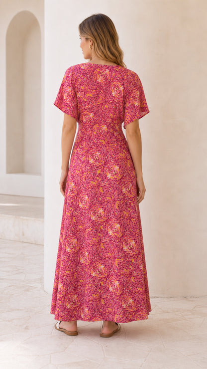 Back view of model wearing fuchsia pink floral flutter sleeve maxi dress