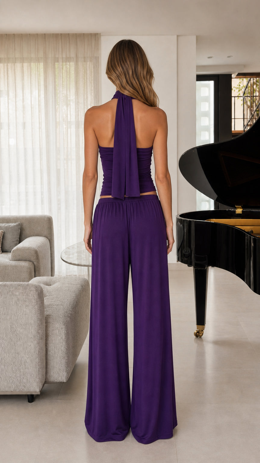 Back view of women's purple halter top showing neck drape and wide-leg pants