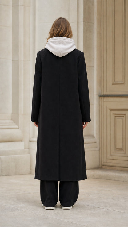 Back view of model wearing classic longline black overcoat