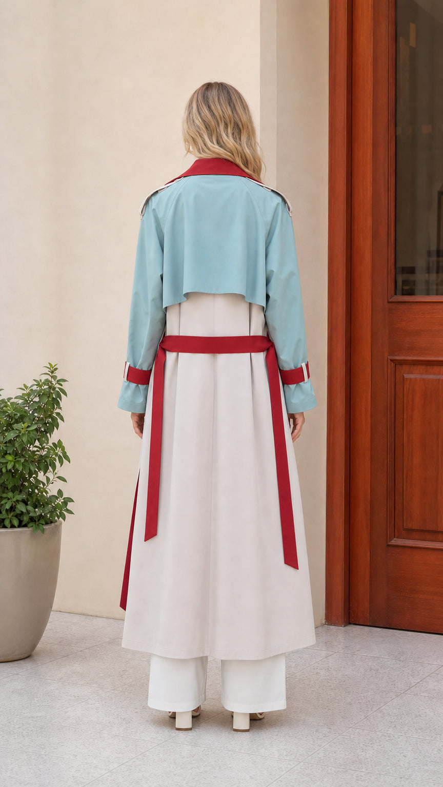 Back view of beige trench coat showing pale teal storm flap and red waist belt