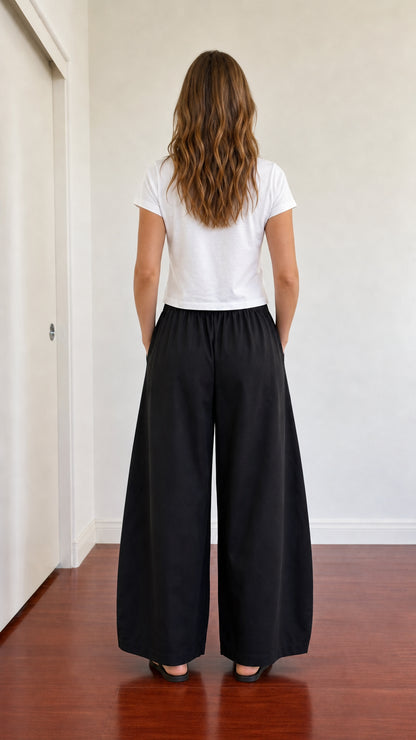 Back view of model wearing full-length black wide leg lounge pants