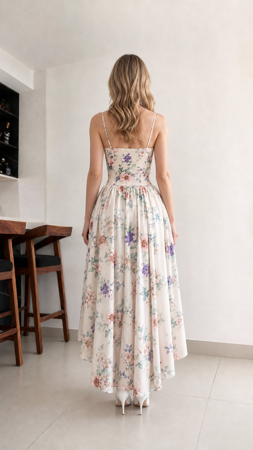 Back view of woman wearing cream floral high-low dress