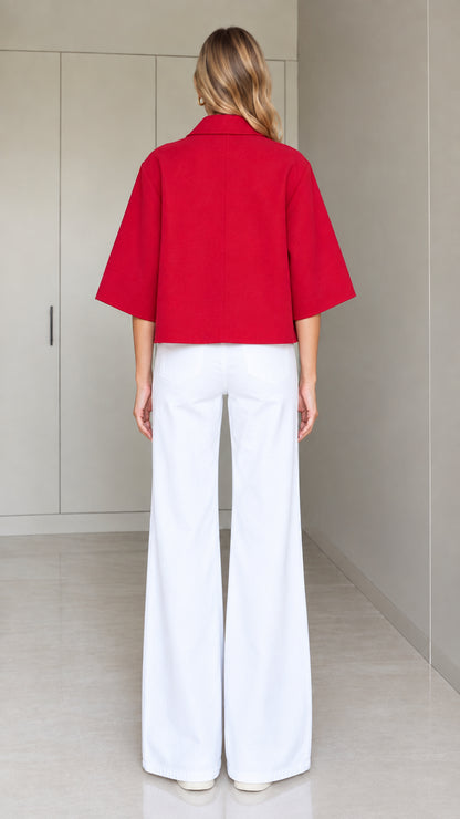 Back full-length view of a red cropped half-sleeve swing jacket showing relaxed silhouette