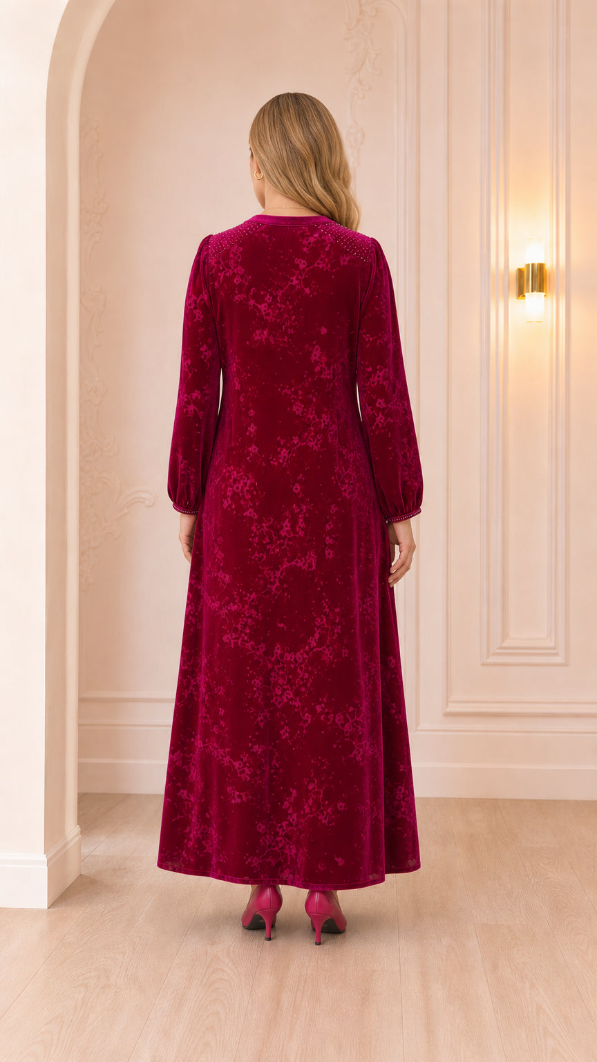 Back view of woman wearing floor-length magenta velvet gown