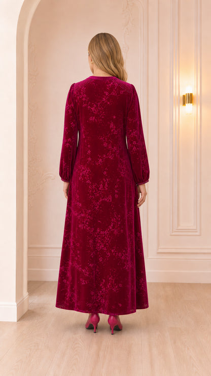 Back view of woman wearing floor-length magenta velvet gown