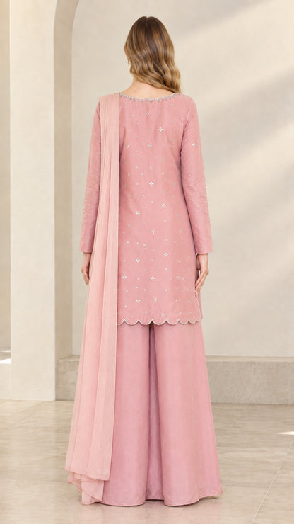 Back view of dusty rose 3-piece formal outfit showing drape and scalloped hem