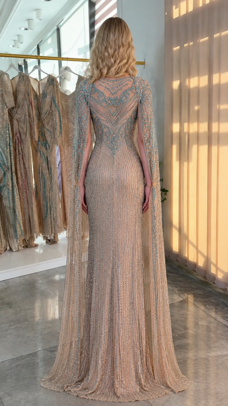 Back view of champagne sequin evening dress with floor-length cape detailing
