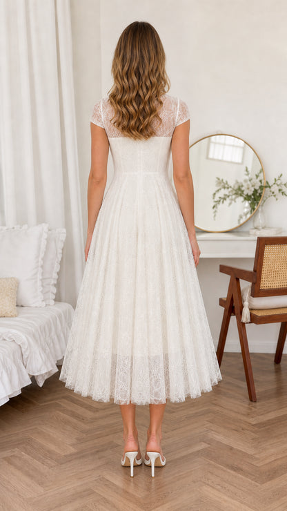 Back view of woman wearing Ivory White flared lace midi dress