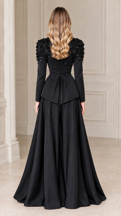 Back view of black evening blazer showing lace-up corset detail and flowing maxi skirt