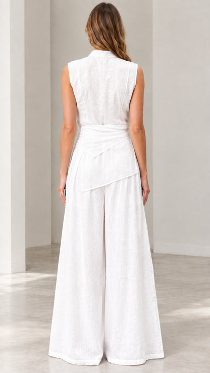 Back view of woman wearing white sleeveless high-waist wide-leg jumpsuit