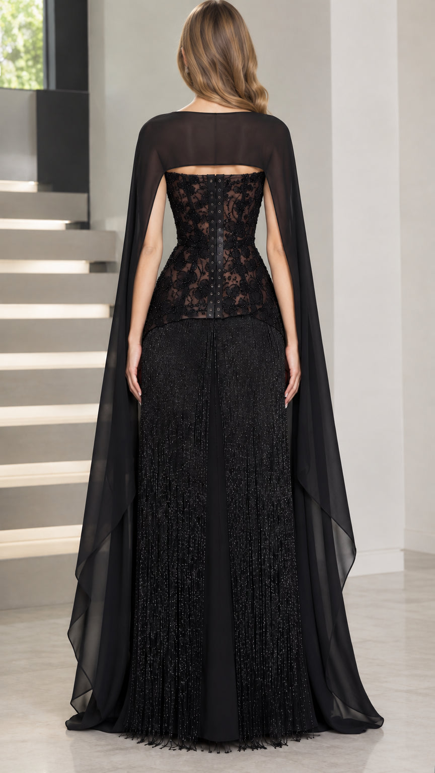 Back view of black evening gown showing corset lace-up closure and sheer cape