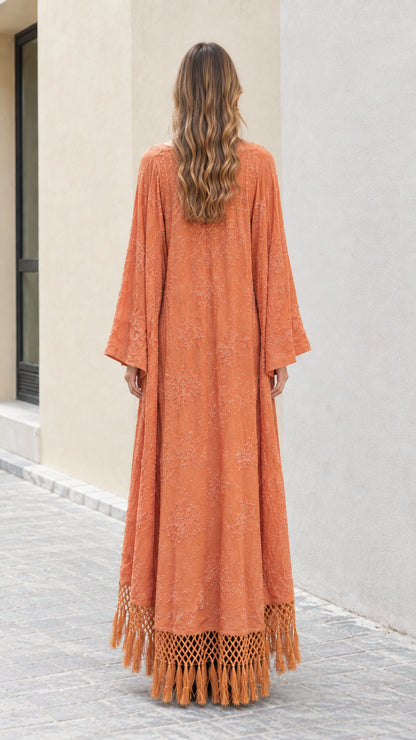 Back view of rust orange maxi kimono cardigan showing full length and fringe hem
