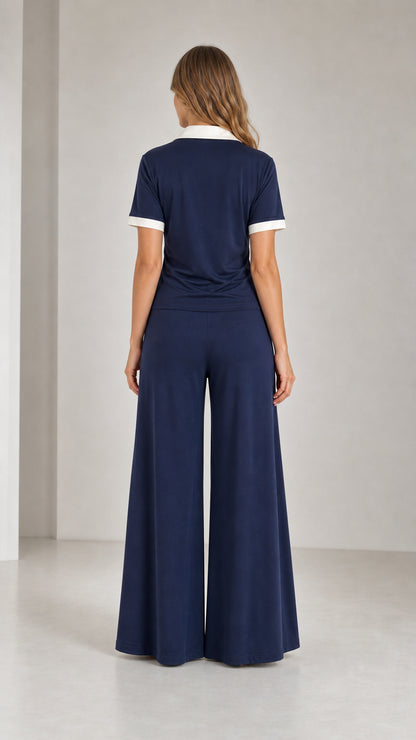 Back view of model wearing Navy Blue polo and wide leg pants two-piece set