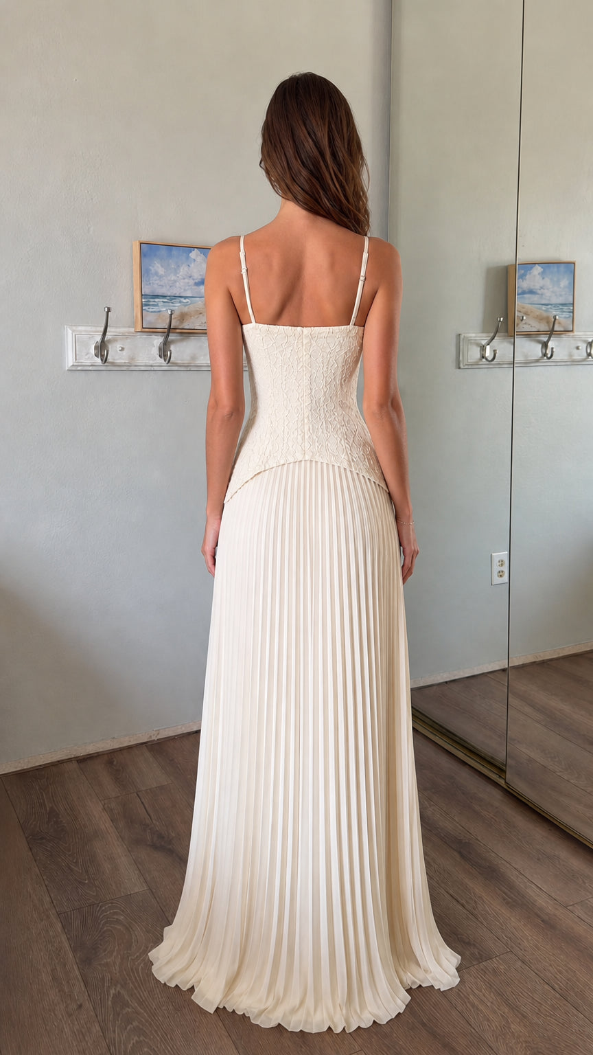 Back view of woman wearing white lace corset bodice pleated maxi dress