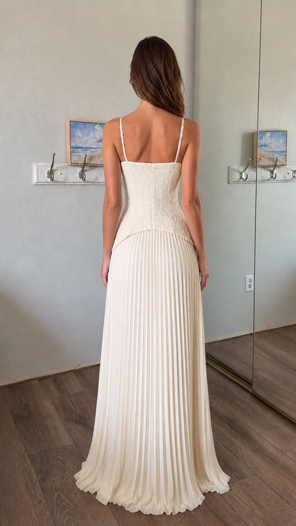 Back view of woman wearing white lace corset bodice pleated maxi dress