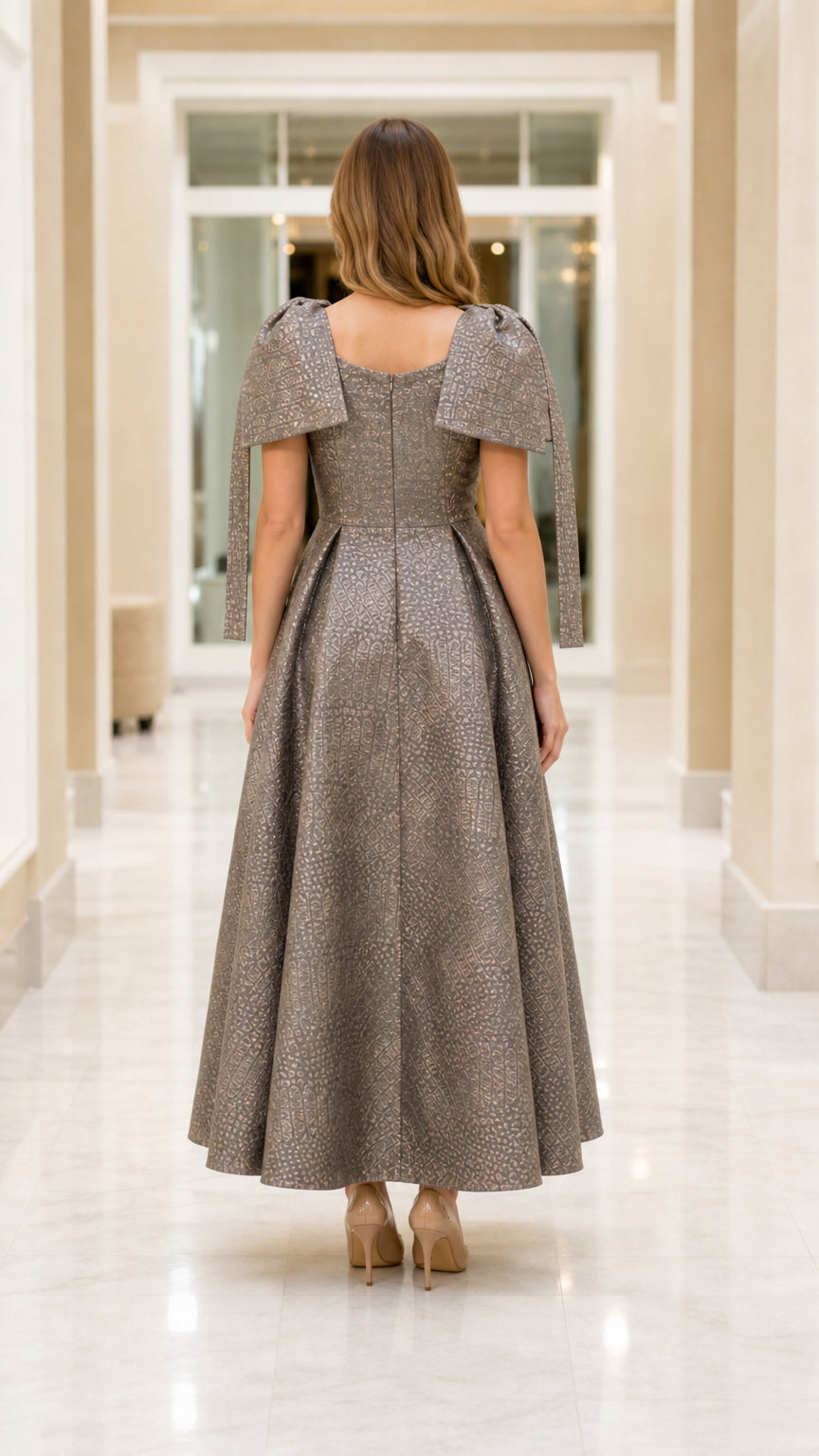 Back view of model in Charcoal Taupe formal dress showing square back and pleated skirt