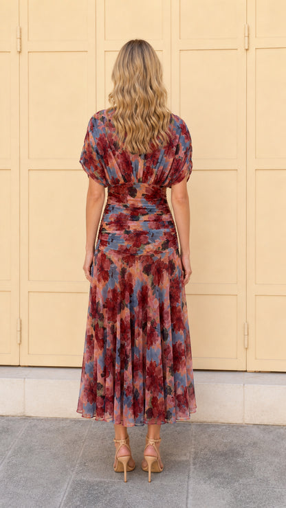 Back view of woman wearing multi pink floral ruched midi dress
