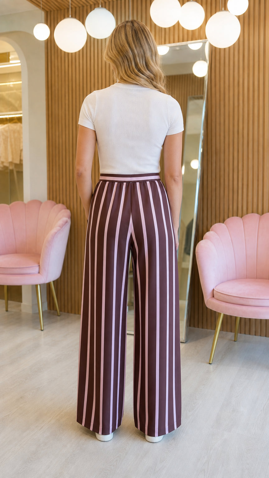 Model wearing burgundy striped wide-leg pants, back view