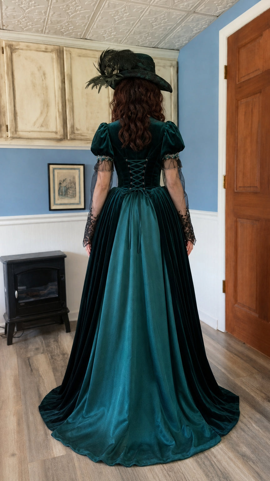 Back view showcasing corset lacing and sweeping train on emerald velvet gown