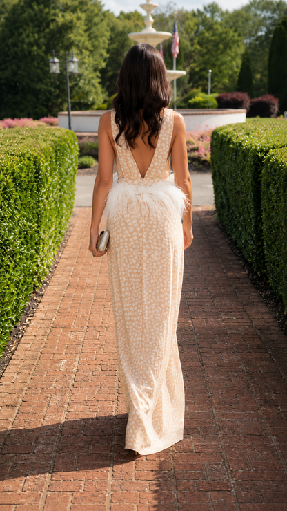 Back view of champagne wide leg jumpsuit with deep V open back and feather-look waist trim
