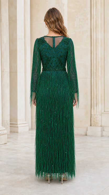 Back view showing sheer illusion paneling on emerald gown