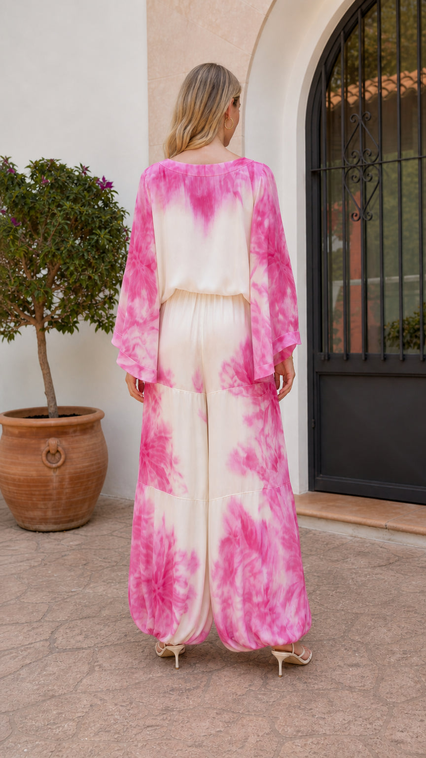 Model wearing pink tie-dye outfit back view