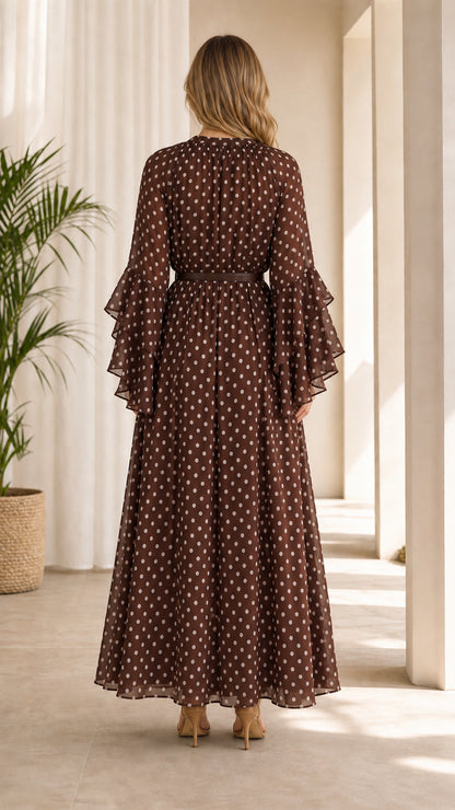Back view of model wearing flowing brown polka dot maxi dress