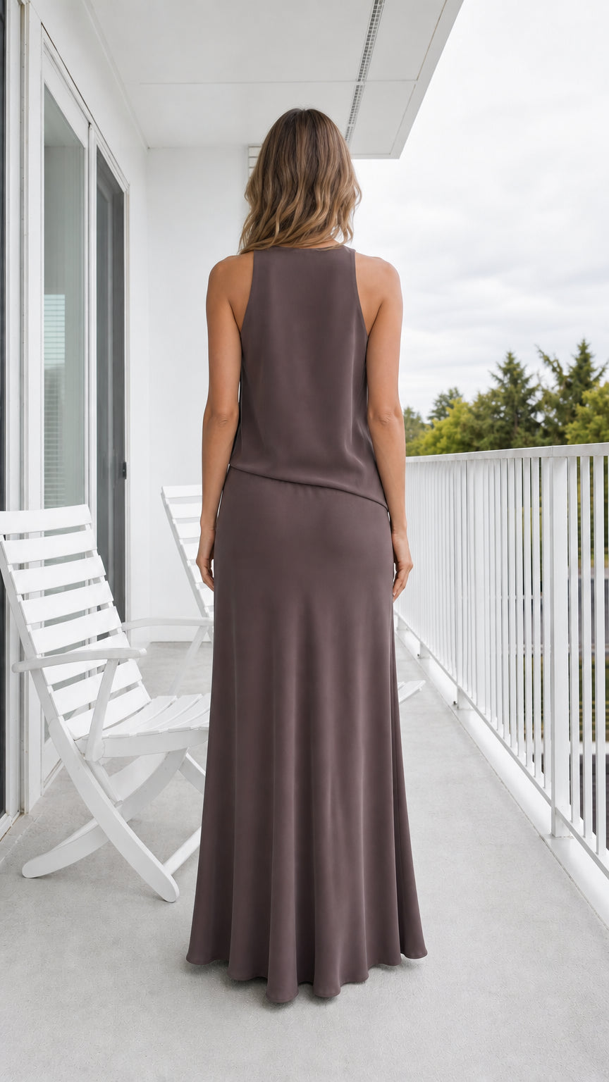 Back view of model wearing taupe sleeveless maxi dress showing tank back cut