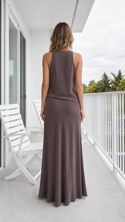 Back view of model wearing taupe sleeveless maxi dress showing tank back cut