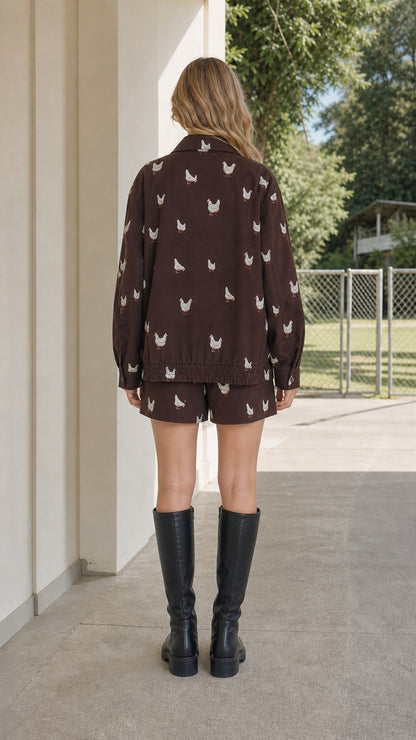 Back full-length view of model wearing brown embroidered matching set