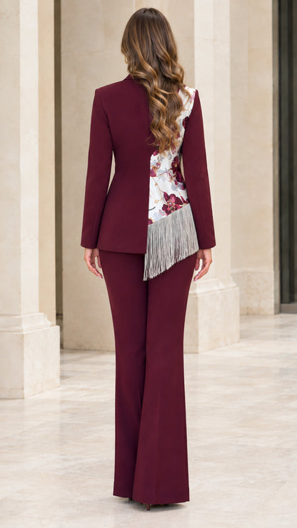 Back view of model in burgundy flared pant suit with floral patchwork details