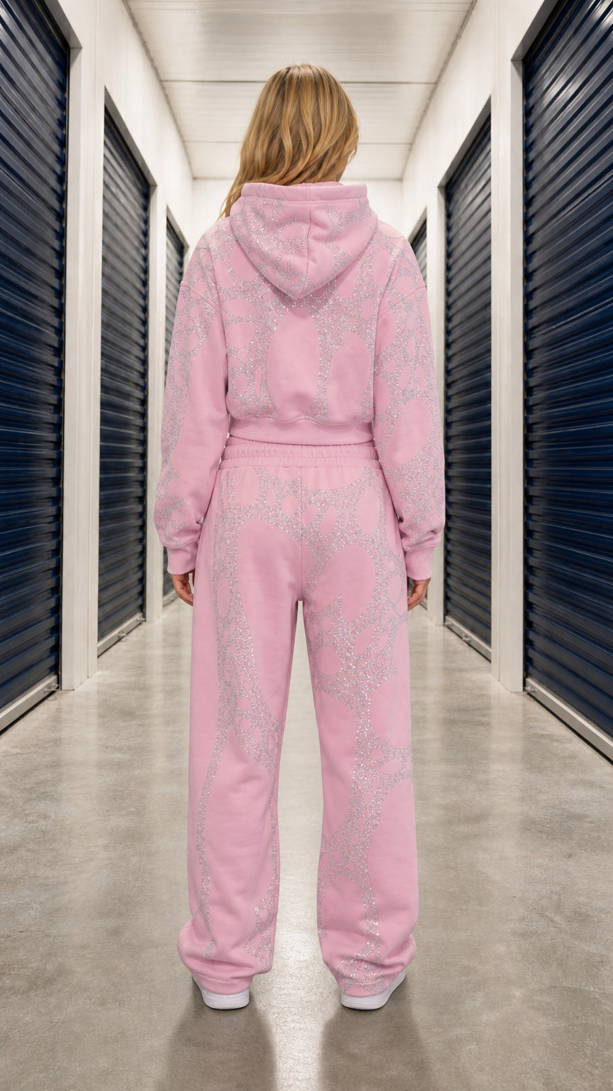 Back view of model in light pink hooded tracksuit set