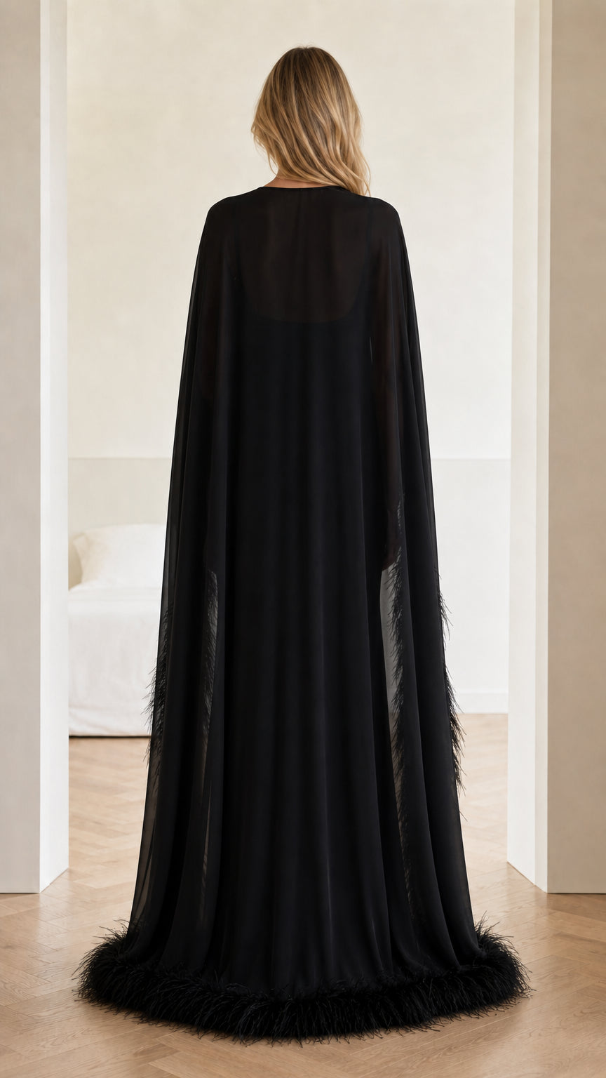 Back view of floor-length black sheer cape evening gown