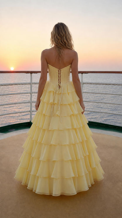 Back view of model in yellow gown showing lace-up corset detail
