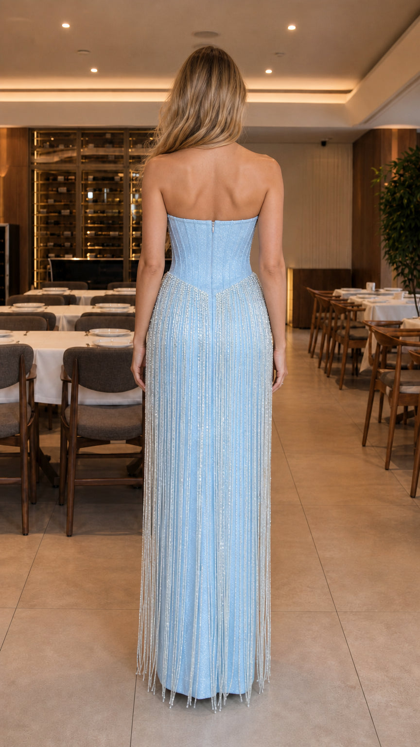 Back view of model wearing Light Blue strapless corseted maxi gown