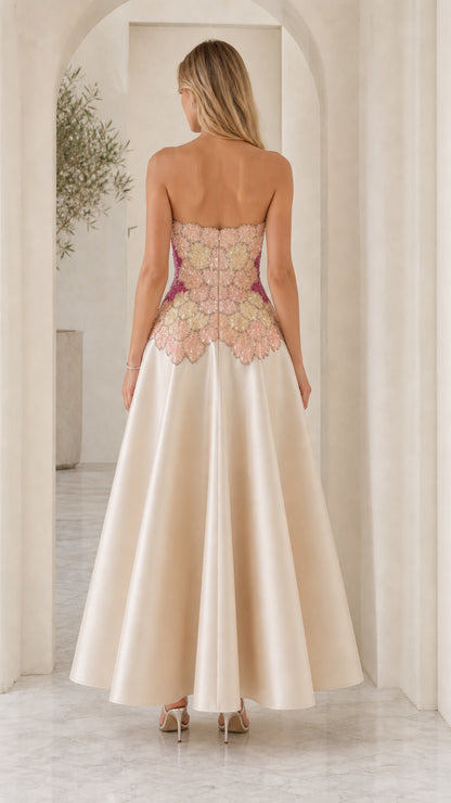 Back view of model in champagne strapless dress