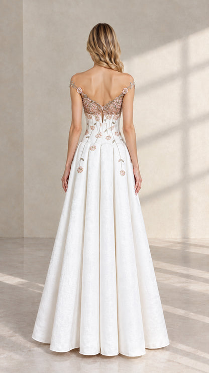 Back view of white formal evening dress featuring illusion V-back and cascading floral embroidery