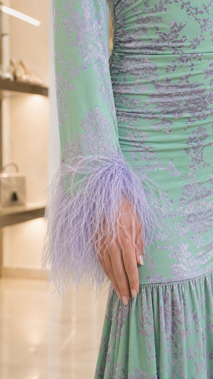 Close-up detail of lilac feather trim on the sleeve cuff and ruched floral jacquard fabric