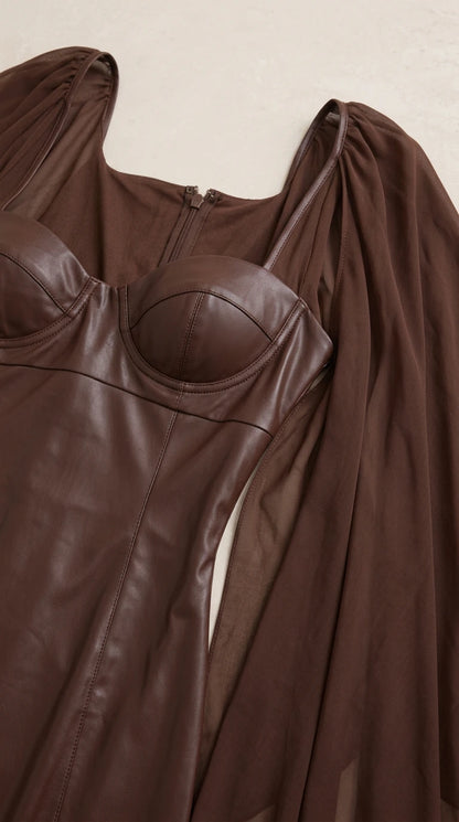Close-up detail of structured faux leather bustier cups and sheer chiffon shoulder attachment