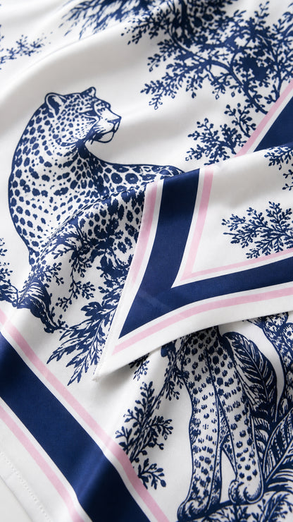 Close-up detail of leopard toile print and contrast borders on silky fabric