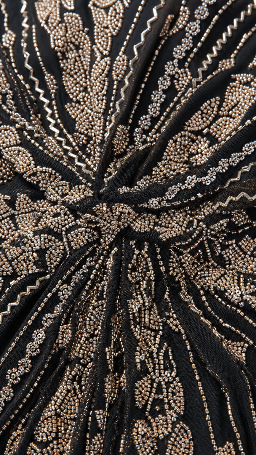 Close-up detail of intricate metallic beading and sequin waist gather