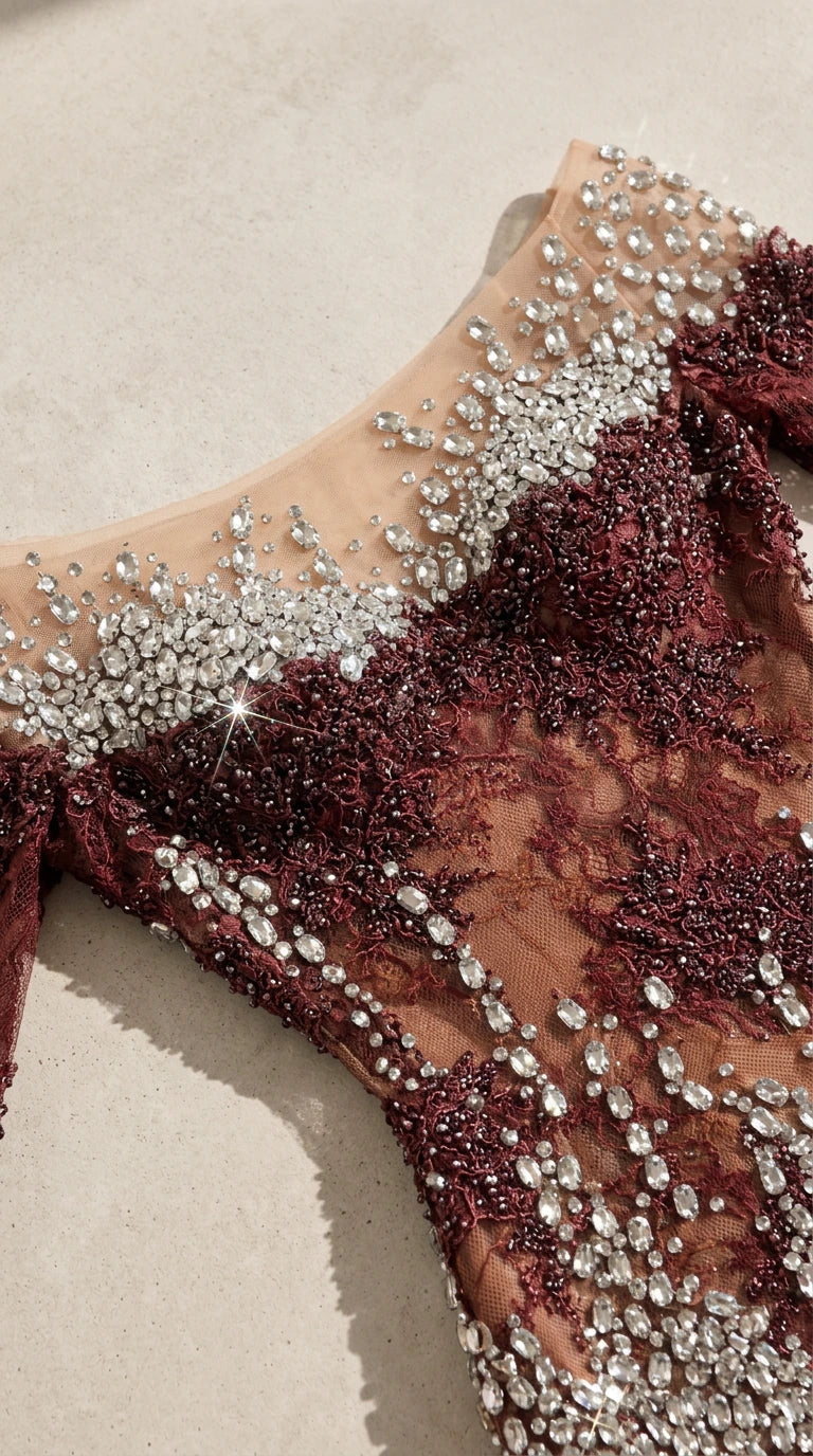 Close-up detail of sheer illusion neckline and sparkling rhinestone embellishments on lace